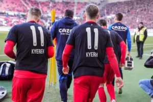 SC Freiburg players support Daniel Kofi Kyereh after being ruled out for the rest of the season with ligament injury