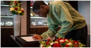 Ghanaian midfielder Kobbie Mainoo signs book of condolence for late Manchester United legend Sir Bobby Charlton